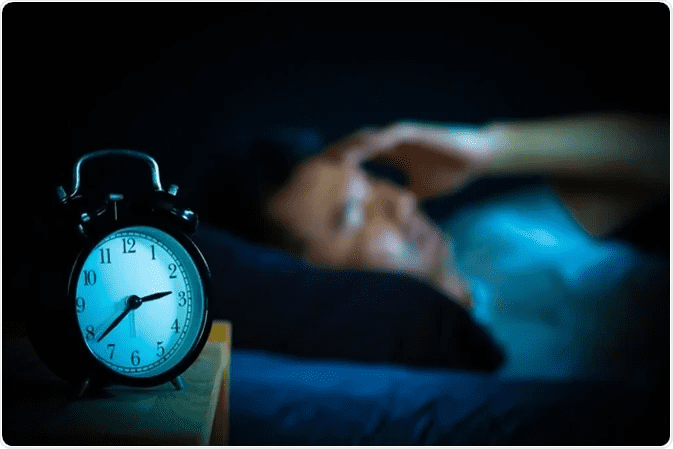 clock in the night with man not sleeping